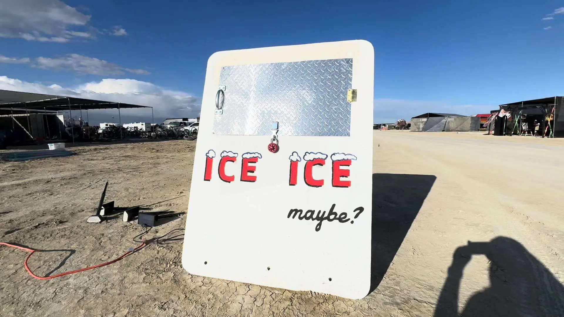 Sandwich board showing Ice Ice Maybe's logo at Burning Man